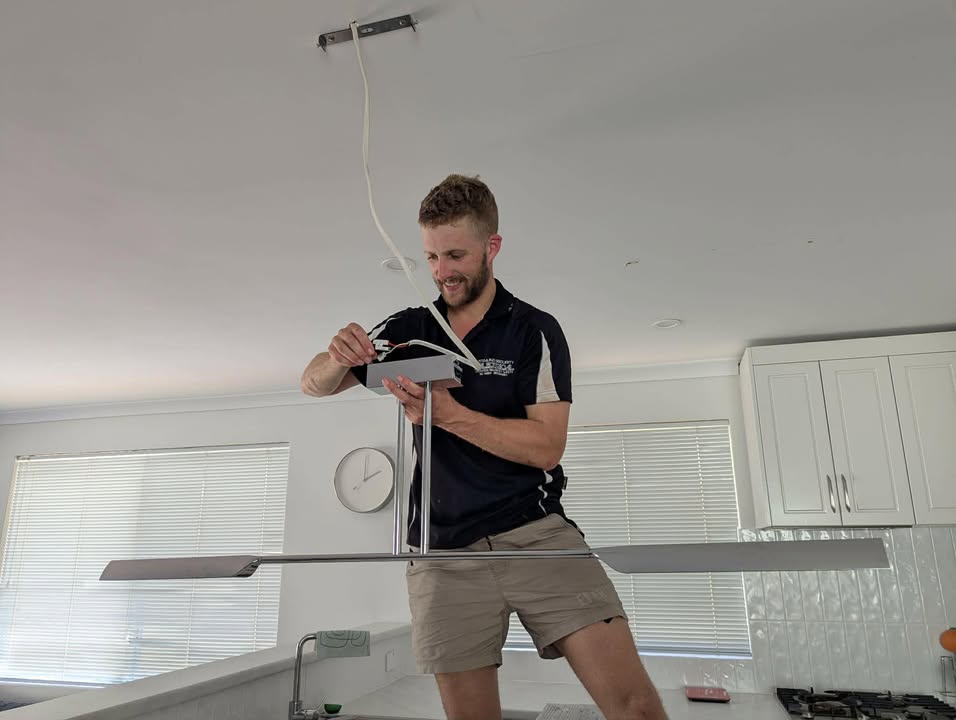 Mitch installing a ceiling fan on the job